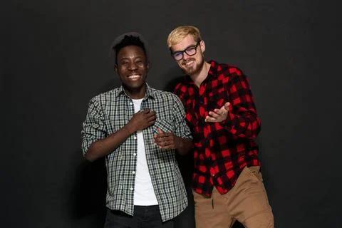 Studio shot of two stylish young men having fun. Handsome bearded hipster in a Stock-Fotos