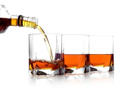 Studio shot of whiskey poured into three glasses Stock Photos