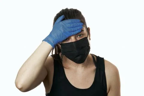 Studio shot on white background of a sick young woman wearing mask and latex  Foto stock