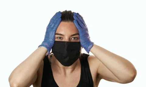 Studio shot on white background of a sick young woman wearing mask and latex  Stock-Fotos