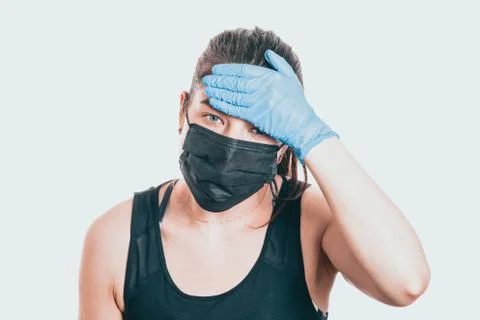 Studio shot on white background of a sick young woman wearing mask and latex  Stock-Fotos