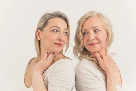 Studio shot on white background of two gorgeous blonde millenial women standing Stock Photos