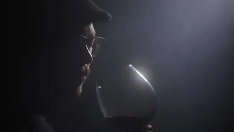 Studio shot of a wine taster  sommelier while smelling a red wine. Awesome light Stock Footage 221720136