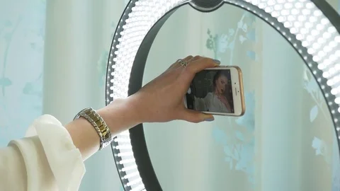 Studio shot of young and beautiful woman taking selfie picture with mobile phone Stock Footage 74984473