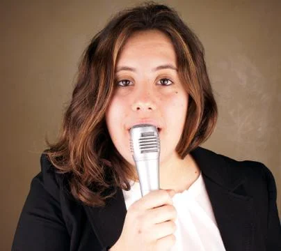 Studio shot of a young lady with microphone Stock Photos