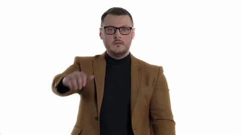 Studio shot of a young man imitates holding a steering wheel and pretending to Stock Footage 123520875