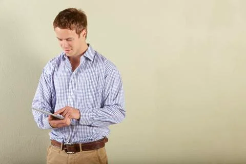 Studio Shot Of Young Man Using Tablet Computer Stock Photos