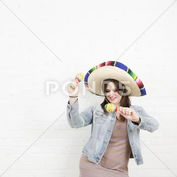 Studio Shot of young woman dancing in sombrero Stock Photos