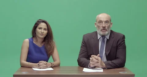 Studio, slow motion, green screen, two presenters at a vintage desk, London, UK Stock Footage 139886223
