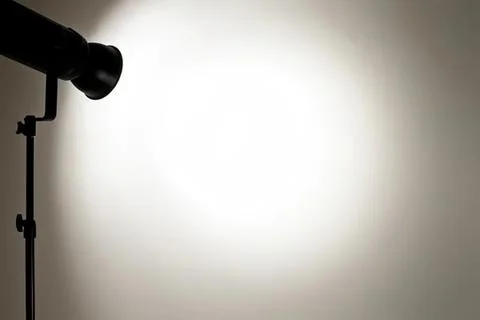 Studio spotlight shining light on blank wall background Stock Photos