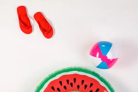 Studio top view shot  of red rubber casual unisex slippers, colorful ball, .. 写真素材