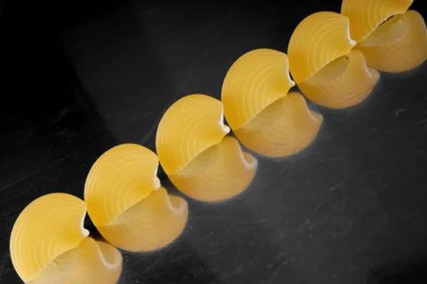 Studioscot of shell pasta pices on black background Stock Photos