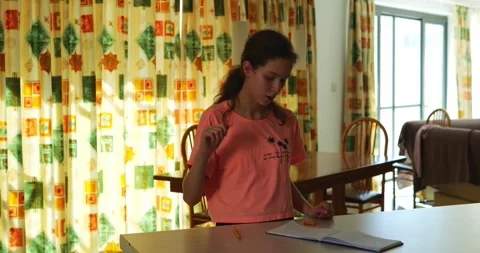 Studious female focuses on notes while performing sign language gestures Stock Footage 310311887