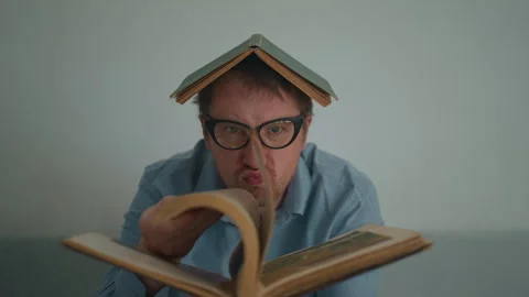 Studious man holding book Stock Footage 240225693