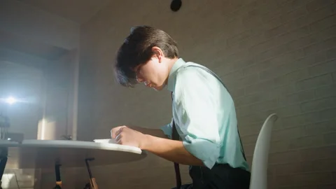 Studious night fatigue. Focused student studying alone. Student immersed in Stock Footage 342065633