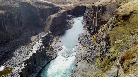 Studlagil canyon, Iceland: turquoise river between basalt columns Stock Footage 346443566