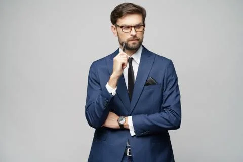 Studuo shot of thinking solving problem businessman wearing suit holding pen Stock Photos