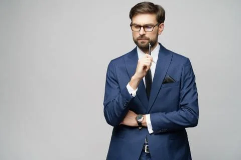 Studuo shot of thinking solving problem businessman wearing suit holding pen Stock Photos