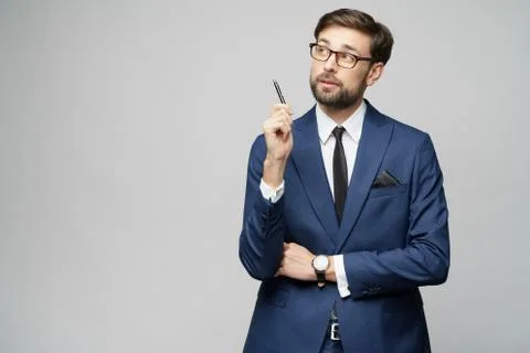 Studuo shot of thinking solving problem businessman wearing suit holding pen Stock Photos