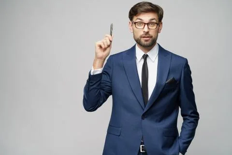 Studuo shot of thinking solving problem businessman wearing suit holding pen Stock Photos