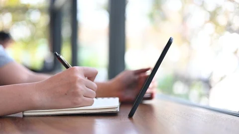 Study and learn by book and internet. Education and working online on summer Stock Footage 124817563