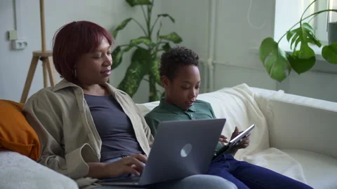 Study and work during pandemic lady works boy asks for help spbd Stock Footage 165527220