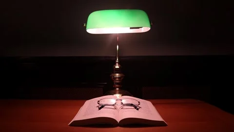 Study Desk Lamp Bulb Bright Open Book Reading Glasses Spectacles Wooden Desk Stock Footage 275620038