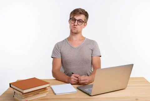 Study, education, people concept - student funny man doing exercises in netbook Stock Photos