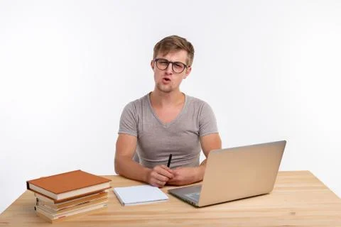 Study, education, people concept - student funny man doing exercises in netbook Stock Photos