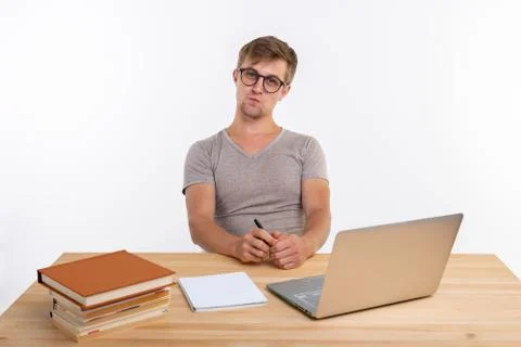 Study, education, people concept - student funny man doing exercises in netbook Stock Photos