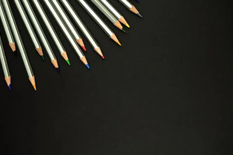 Study equipment flat lay background. Black office desktop with color pencils Stock Photos