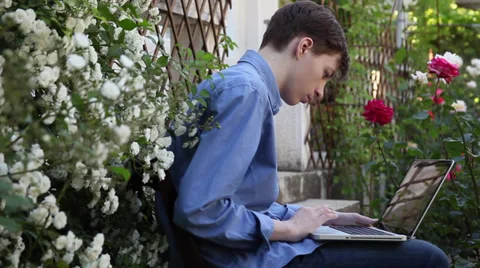 Study for exams in flower garden, preparing, working, school, laptop Stock Footage 39654894
