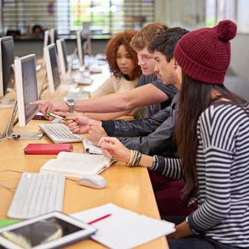Study group, students and computer in library for education, assignment and Stock Photos