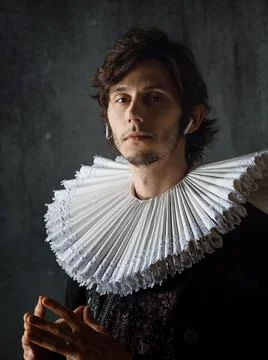 Study the history of art, an audio guide. young man in medieval collar and suit 写真素材