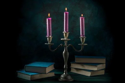 Study of magic. Old books and purple candles Foto stock