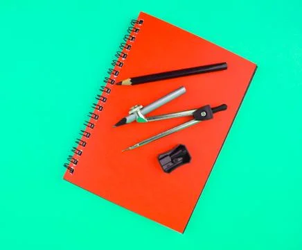 Study material containing a pencil compass,a pencil sharpener a crayon on top Stock Photos