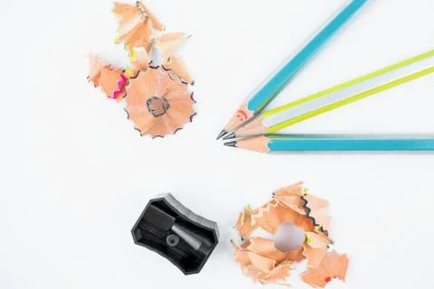 Study materials containing black color pencil sharpener and three wood pencil Stock Photos