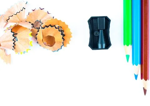 Study materials containing some pencil shavings a pencil sharpener and a gree Stock Photos