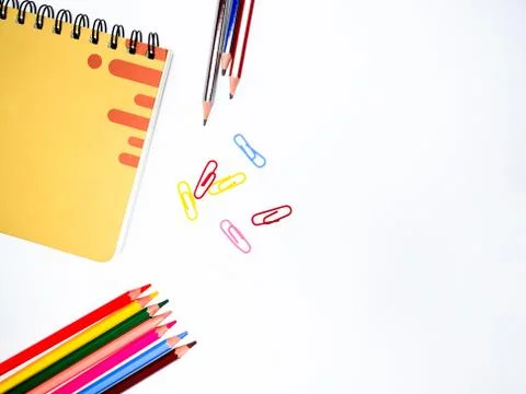 Study materials scattered on a white table,which contains a notebook ,some pe Stock Photos