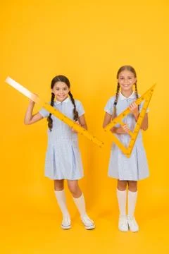 Study math. School students study math. Pupil school girls rulers. School Stock Photos