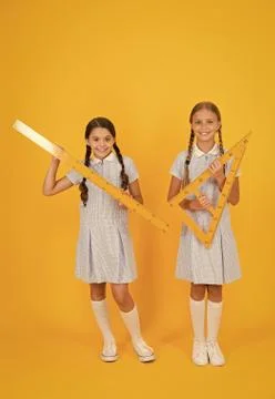 Study math. School students study math. Pupil school girls rulers. School Stock Photos