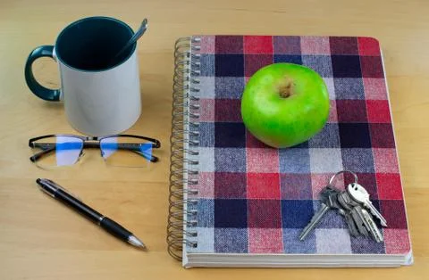 Study notebook with glasses, pen, breakfast cup and apple Stock Photos