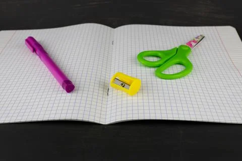 A study notebook a pen a sharpener and scissors Stock Photos