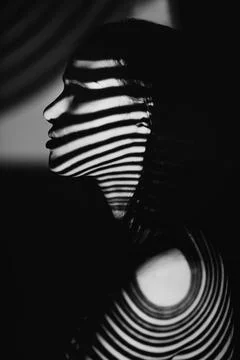 Study in pattern and beauty. Monochrome studio shot of a woman with patterns Stock Photos