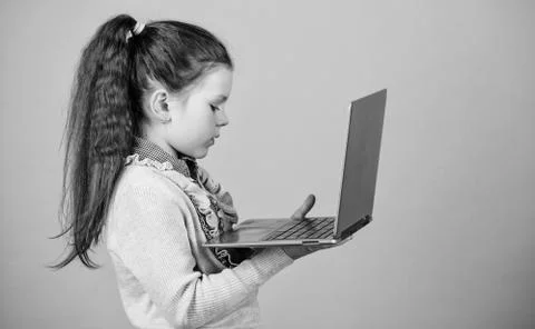 Study programming. Blogging concept. Girl with laptop computer. Little child Foto stock