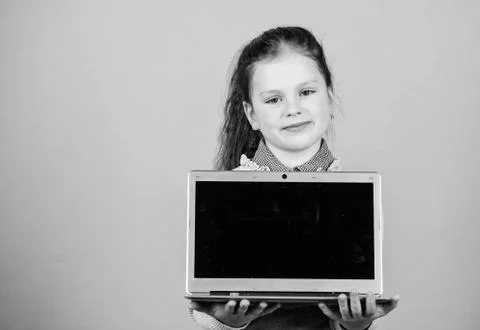 Study programming. Girl with laptop computer. Little child using pc. Life online Stock Photos