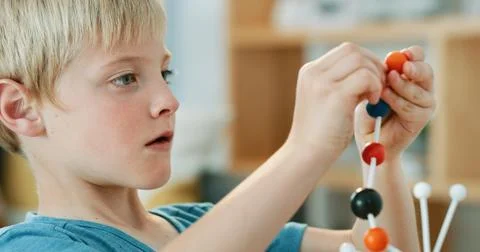 Study, science and kid with atom model for project, education or assignment.. Stock Photos