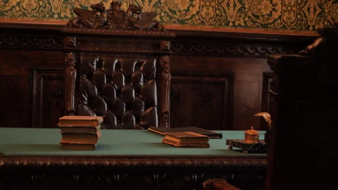 Study stately green desk, large leather chairs. There stacks of books on desk Stock Footage 273855931