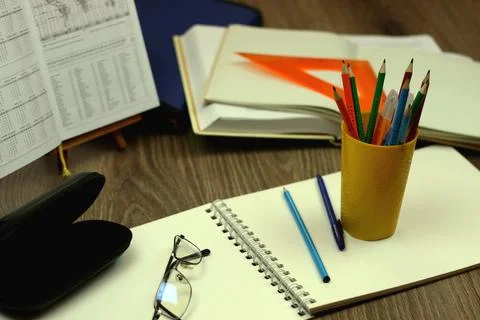 Study table with textbooks and pencils Stock Photos