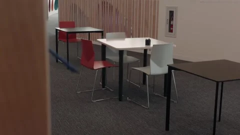 Study tables and chairs inside modern public library slow motion pan Stock Footage 332037332